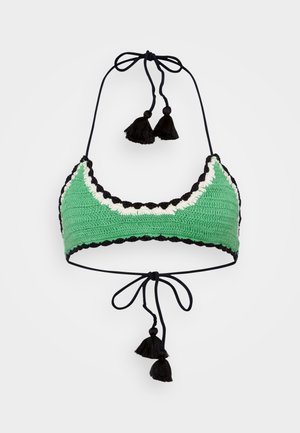 Crochet bikini top in green with black and cream scalloped accents. Features black ties and tassels for adjustment. Textured design.