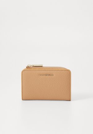 Coccinelle leather wallet in light beige, rectangular shape with textured finish, gold-tone zipper, and logo detail on the front.