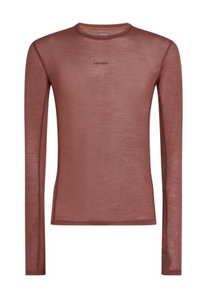 Langarmshirt in diep roestkleur, gemaakt van geweven stof met een honingraatpatroon. Heeft een ronde halslijn en subtiele branding.
