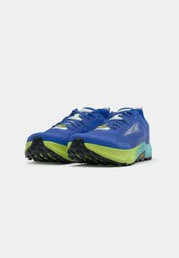 Chaussures de trail running avec un dessus bleu, des accents noirs et verts fluo, un matériau en maille texturée et une semelle extérieure noire robuste.
