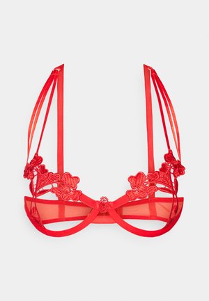 Red bra featuring floral lace detailing, sheer mesh cups, and satin straps. Center bow accent with adjustable straps and hook closure.