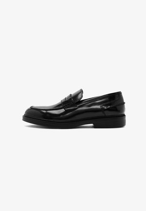 Black leather loafers with a shiny patent finish, a rounded toe, and a stitched accent. The sole is flat with a slight lift.