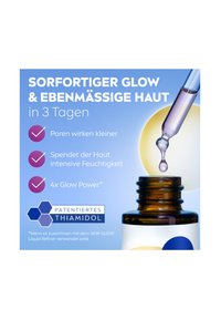 Amber glass bottle with a dropper, featuring a blue and white label. Text highlights skin benefits and key ingredient, Thiamidol.