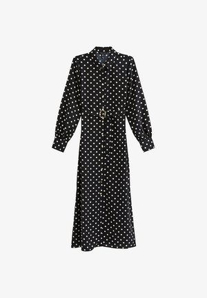 Abito midi nero a maniche lunghe con pois bianchi, chiusura frontale con bottoni, collo e cintura abbinata con fibbia rettangolare.