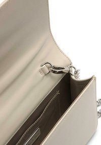 Bolso cruzado de cuero beige con cierre de clip plateado, exterior suave y un interior de tela marrón que cuenta con ranuras para tarjetas y detalles de costura.