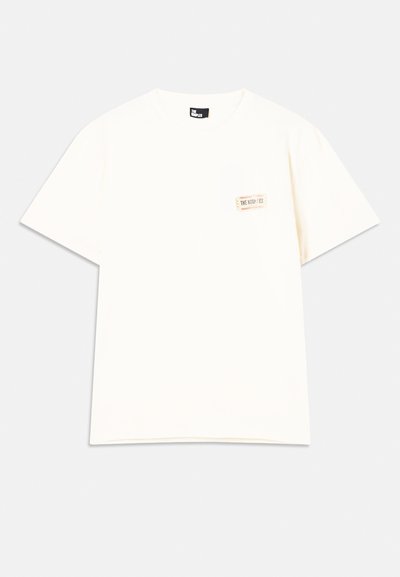 Cream short-sleeve t-shirt made of cotton, featuring a small pocket with label detail in the upper left corner. Round neck design.