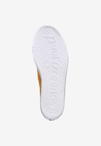 Semelle de chaussure en caoutchouc blanc texturé, avec texte en relief et motifs circulaires. Design latéral orange-jaune, bords lisses.