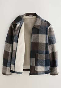 Plaid zip-up jacket with large pockets, in shades of brown, gray, and navy, featuring a soft cream fleece lining inside.