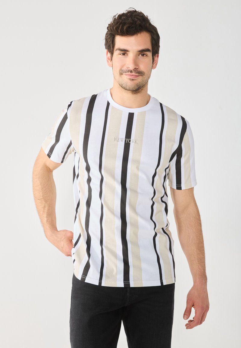 Striped T-shirt in white, black, and beige; features horizontal stripes and "NEW YORK" text in the center; cotton material, regular fit.