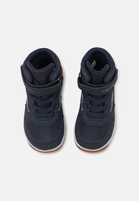 Navy blue high-top sneakers made of durable fabric and synthetic materials. Features laces and a Velcro strap for secure fitting.