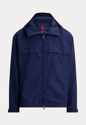 Marineblauwe lichtgewicht jas met rits, opstaande kraag, knoopmanchetten en zijzakken, Polo Ralph Lauren-logo op de borst.