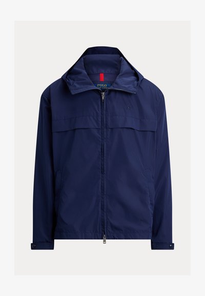 Veste légère bleu marine zippée avec col montant, poignets boutonnés et poches latérales, logo Polo Ralph Lauren sur la poitrine.
