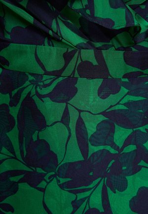 Tessuto verde con motivo floreale di foglie blu navy scuro e dettaglio di cuciture raccolte al centro.