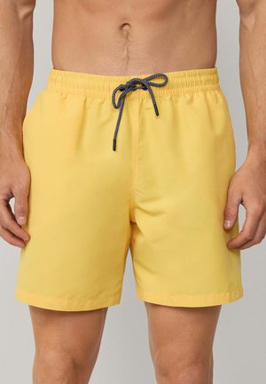 Gelbe Schwimm shorts mit elastischem Bund, schwarzem Kordelzug und Seitentaschen. Glatte Textur; knielange Passform.