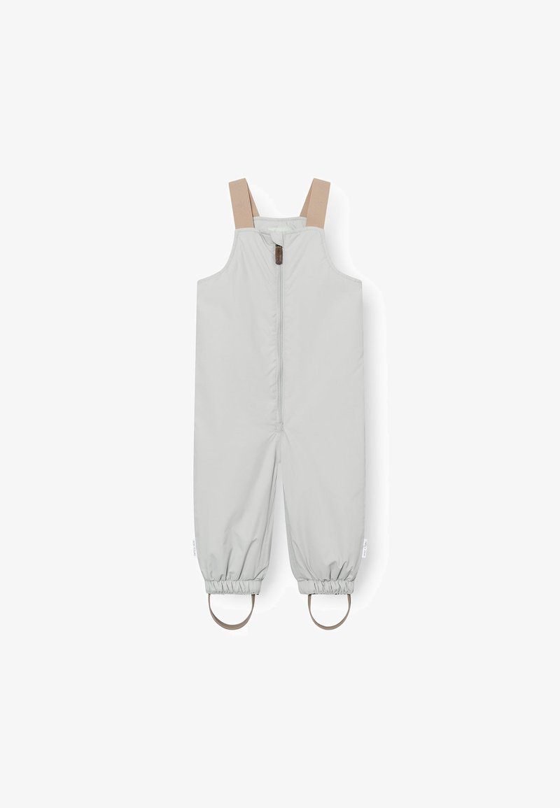 Salopette pour enfants en tissu gris clair avec des bretelles beiges réglables, une fermeture éclair à l'avant, des poignets élastiques et des accents en caoutchouc circulaires au niveau des chevilles.