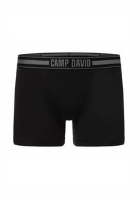 Boxer da uomo neri realizzati in tessuto morbido con una vestibilità aderente. Presentano un elastico grigio in vita con la scritta "CAMP DAVID" stampata in grassetto.