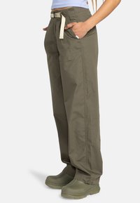 Olive green cargo pants with a relaxed fit, drawstring waistband, side pockets, and a smooth, durable fabric texture.