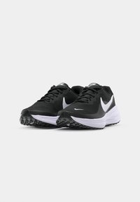 Black athletic shoes with a textured mesh upper, white brand logo, and a white midsole. Features a rubber outsole with traction pattern.