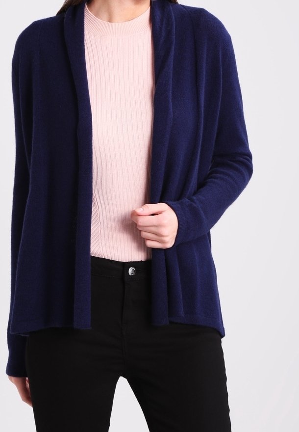 Navy blue cardigan with an open front, long sleeves, and a soft texture, layered over a light pink ribbed shirt and black pants.