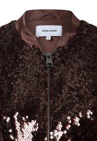 Brown bomber jacket with sequin embellishments, featuring a ribbed collar and zip closure. Smooth fabric interior complements shiny exterior.