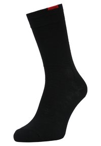 Schwarze Baumwollsocke mit geripptem Bund und rotem Akzent oben. Verfügt über eine glatte Textur und ein Standard-Crew-Längen-Design.