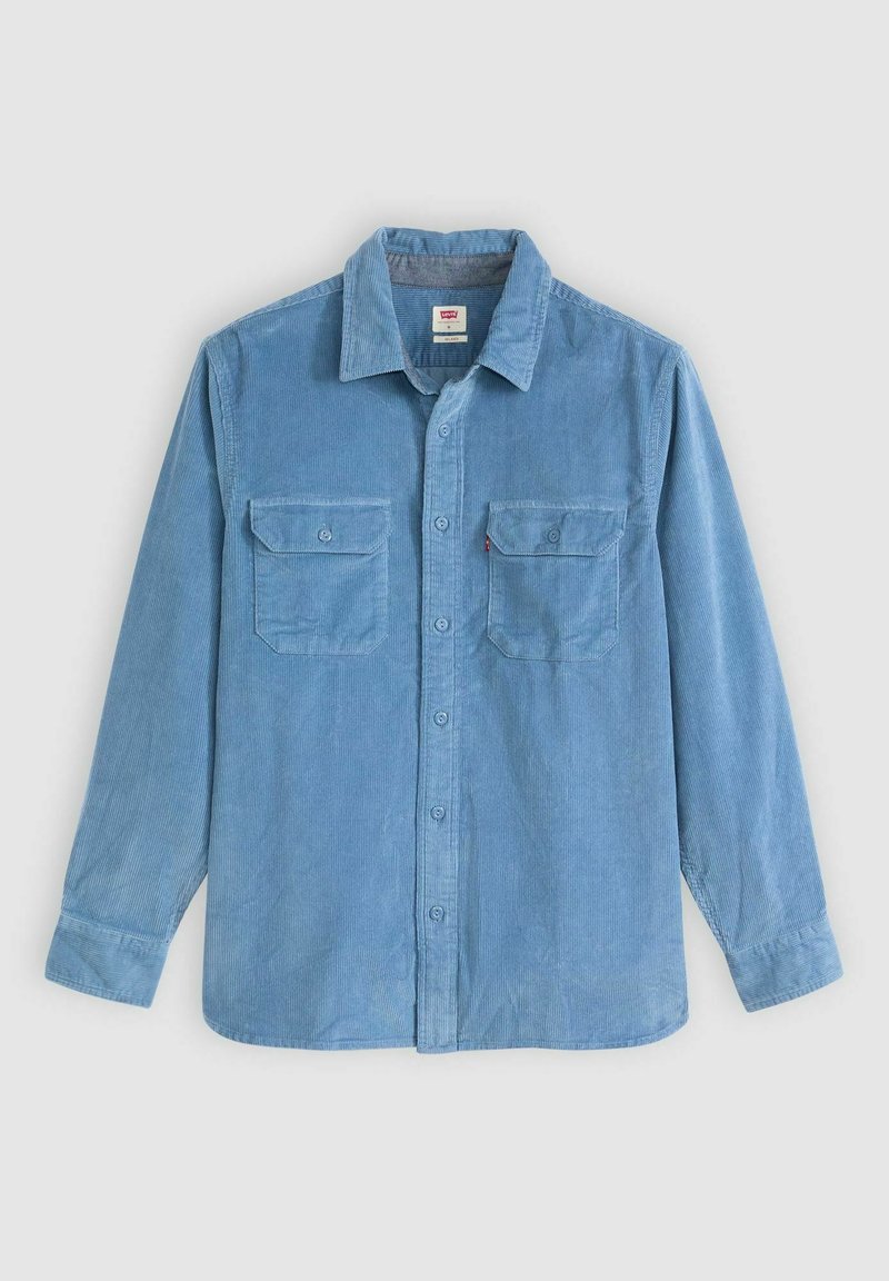 Lys blå kordfløjlsskjorte med button-down krave, to brystlommer og lange ærmer. Har tekstureret stof og kontrastknapper.