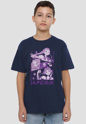 Navy blue cotton t-shirt featuring a graphic print with three cartoon characters in purple and white, text "HUNTRAX" at the bottom.
