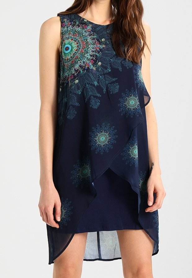 Robe bleu marine sans manches avec un ourlet superposé asymétrique et des motifs floraux circulaires multicolores à l'avant et sur les côtés.
