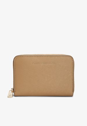 Beige textured wallet made of leather with a zip closure. Features embossed brand logo and a small metal charm. Compact rectangular shape.
