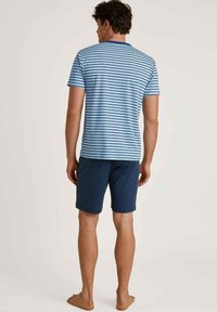 Striped short-sleeve blue shirt with white stripes, paired with solid navy shorts. Relaxed fit, casual fabric, no notable details.