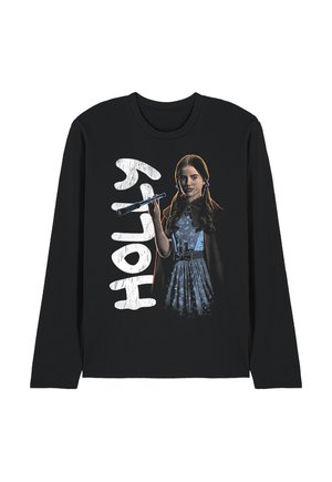 Girl with long hair in a blue dress and cape holding a wand, with the word "HOLLY" in large white letters beside her on a black long-sleeve shirt.