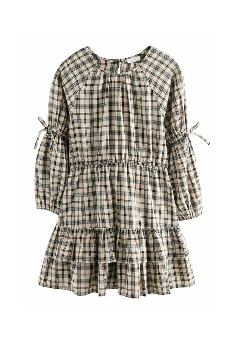 Robe à manches longues à carreaux beige et noire avec jupe à volants, taille froncée et liens aux manches.