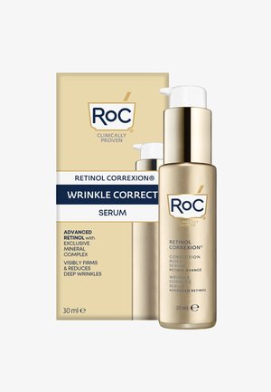 Goldene Flasche mit einem weißen Pumpenkopf, beschriftet mit "Retinol Correxion Wrinkle Correct Serum." Die Box hat goldene und blaue Akzente, die die wichtigsten Vorteile auflisten.