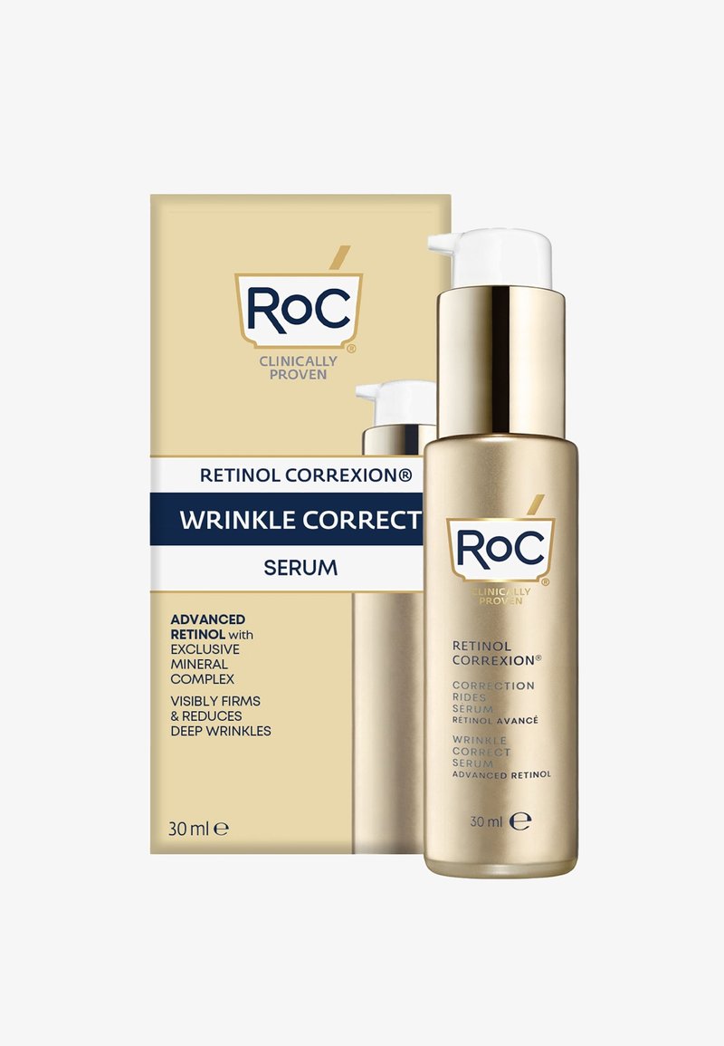 Gouden fles met een witte pompdeksel, gelabeld "Retinol Correxion Rimpel Correctie Serum." De doos heeft gouden en blauwe accenten en vermeldt de belangrijkste voordelen.