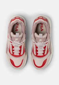 Une paire de baskets FILA roses et rouges avec des lacets blancs, vue de dessus sur un fond blanc uni.
