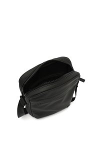Black leather crossbody bag with a zipper closure, flat design, adjustable strap, and smooth texture. Interior is unlined.