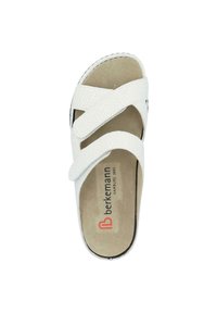White slide sandal with textured straps crossing over the top. Soft footbed and visible brand logo in red and black on the insole.