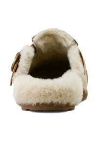 Brown suede slipper with a fluffy beige wool lining. Rounded shape, open back design, and a side button detail. Soft textured interior.