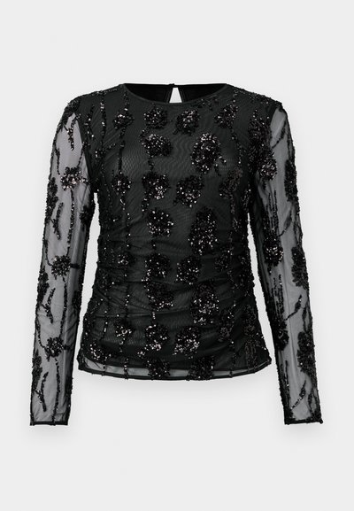 Fekete, hosszú ujjú felső áttetsző anyagból, hímzett virágmintákkal díszítve, amelyeket flitterek ékesítenek, és a testen ráncolt részletekkel van ellátva.