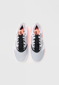 Gray sneakers with black and white accents, featuring a perforated toe box and vibrant pink detailing on the tongue and sole. Laced design.