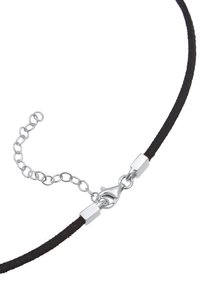 Black suede choker necklace with silver-toned clasp and adjustable chain. Soft texture, slim design, and minimalistic hardware accents.