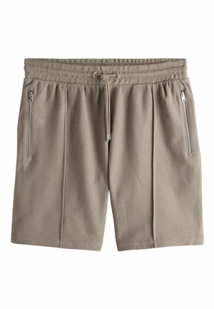 Beige strukturierte Stoffshorts mit elastischem Bund, Kordelzug und vertikalen Reißverschlusstaschen auf beiden Seiten.