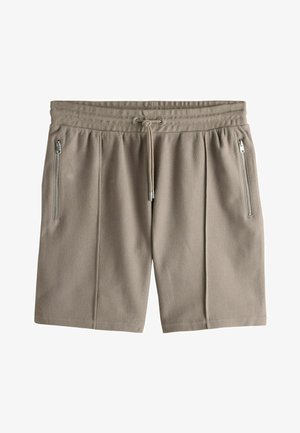 Beige strukturierte Stoffshorts mit elastischem Bund, Kordelzug und vertikalen Reißverschlusstaschen auf beiden Seiten.