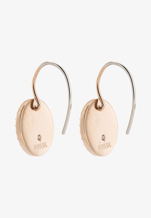 Rose gold oval earrings with a polished finish, featuring a silver hook and a small crystal accent. Branding "FOSSIL" displayed.