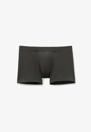 Tmavě šedé boxerky z měkké látky, s přiléhavým střihem a tvarovaným předním dílem. Hladké švy bez viditelných vzorů nebo kovových částí.