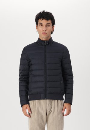 Dark blue puffer jacket with a high collar, zip closure, and side pockets. Features horizontal quilted pattern and ribbed hem.
