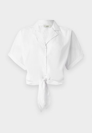 Bijela skraćena košulja s kratkim rukavima i ovratnikom, s čvorom sprijeda i zatvaranjem u sredini na dugmad. Glatka tekstura tkanine.