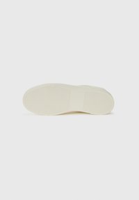 White rubber sneaker sole with textured grip. Features rounded toe and flat heel. Clean design without visible branding or patterns.