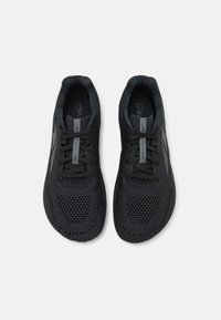 Black athletic shoes with a breathable mesh upper, textured laces, and padded collar. Features a sleek, modern design and subtle logo accents.
