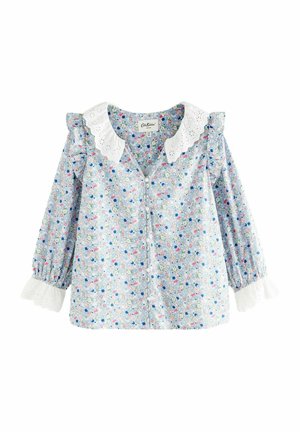 Top blu floral con bottoni, colletto in pizzo bianco, spalle con volant e maniche lunghe con bordo bianco ai polsini.